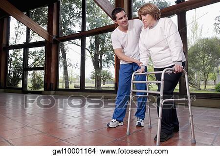 Physiotherapist assisting a woman in walking View Large Photo Image Picture - Physiotherapist assisting a woman in walking. Fotosearch