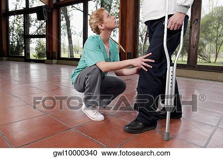 Physiotherapist assisting a woman in walking View Large Photo Image Stock Image - Physiotherapist assisting a woman in walking. Fotosearch