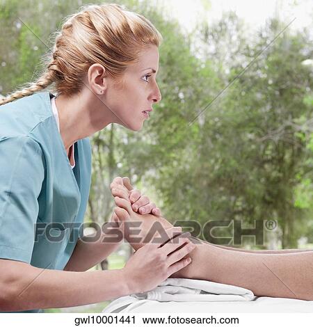 Physiotherapist massaging a person's foot View Large Photo Image Stock Image - Physiotherapist massaging a person's foot. Fotosearch
