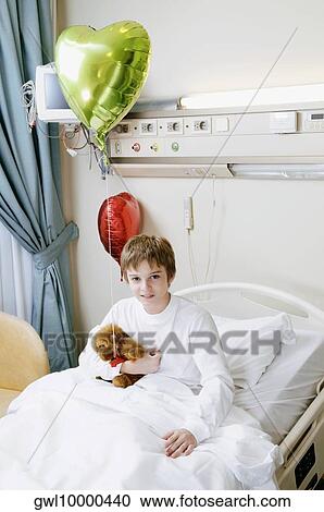 Portrait of a boy sitting on a hospital bed View Large Photo Image Stock Image - Portrait of a boy sitting on a hospital bed. Fotosearch