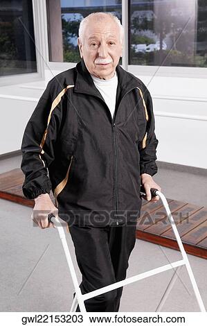 Stock Image - Portrait of a disabled man walking with a walker. Fotosearch