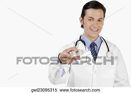 Portrait of a doctor holding a blister pack capsules View Large Photo Image Stock Photography - Portrait of a doctor holding a blister pack capsules. Fotosearch
