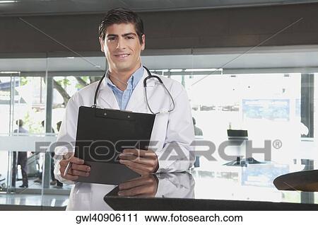 Portrait of a doctor holding a clipboard View Large Photo Image Stock Image - Portrait of a doctor holding a clipboard. Fotosearch