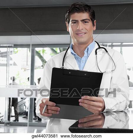 Portrait of a doctor holding a clipboard View Large Photo Image Stock Image - Portrait of a doctor holding a clipboard. Fotosearch