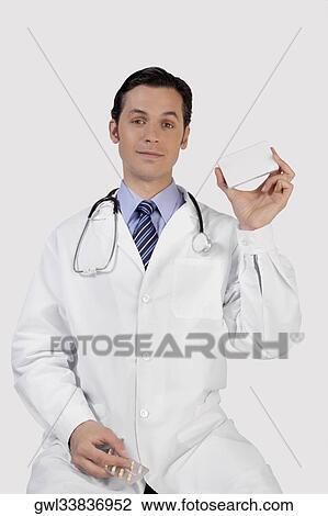 Portrait of a doctor holding a medicine pack View Large Photo Image Stock Image - Portrait of a doctor holding a medicine pack. Fotosearch