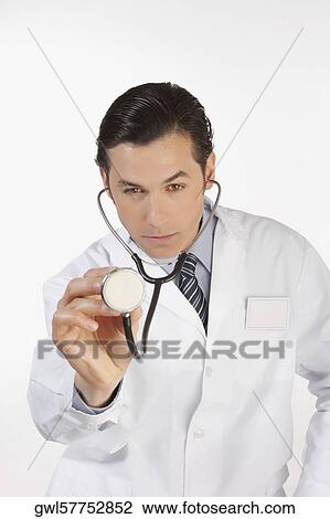 Portrait of a doctor holding a stethoscope View Large Photo Image Stock Image - Portrait of a doctor holding a stethoscope. Fotosearch