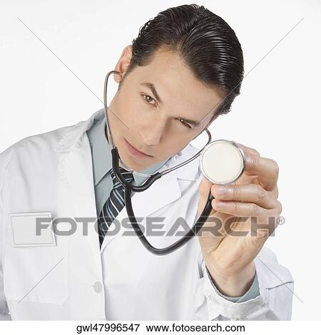 Portrait of a doctor holding a stethoscope View Large Photo Image Stock Photo - Portrait of a doctor holding a stethoscope. Fotosearch