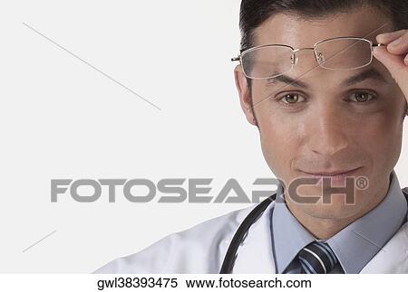 Portrait of a doctor holding eyeglasses View Large Photo Image Stock Photography - Portrait of a doctor holding eyeglasses. Fotosearch