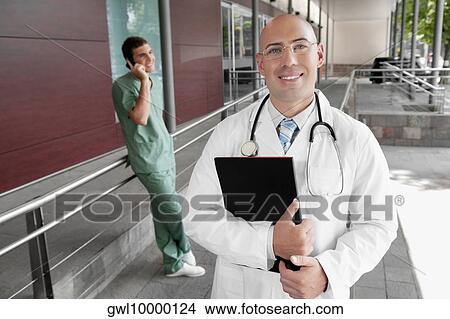 Portrait of a doctor smiling View Large Photo Image Picture - Portrait of a doctor smiling. Fotosearch