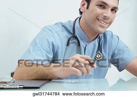 Portrait of a doctor smiling View Large Photo Image Picture - Portrait of a doctor smiling. Fotosearch