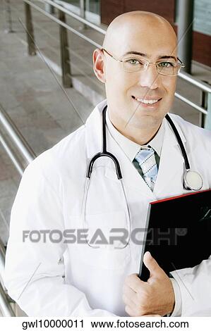 Portrait of a doctor smiling View Large Photo Image Stock Image - Portrait of a doctor smiling. Fotosearch