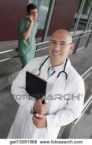 Portrait of a doctor smiling View Large Photo Image Stock Photo - Portrait of a doctor smiling. Fotosearch