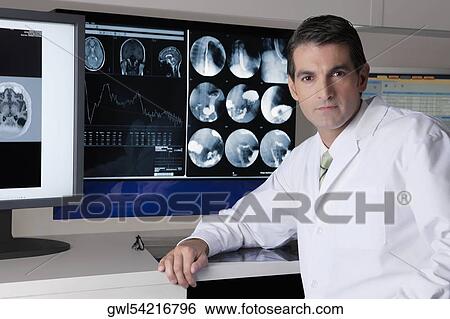 Portrait of a doctor with MRI report View Large Photo Image Stock Photograph - Portrait of a doctor with MRI report. Fotosearch