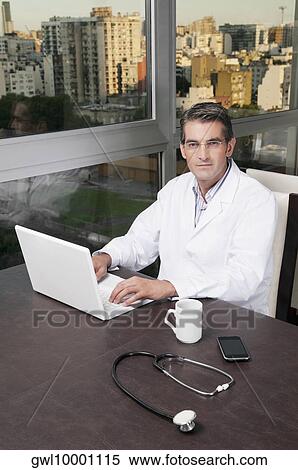 Stock Photography - Portrait of a doctor working on a laptop. Fotosearch
