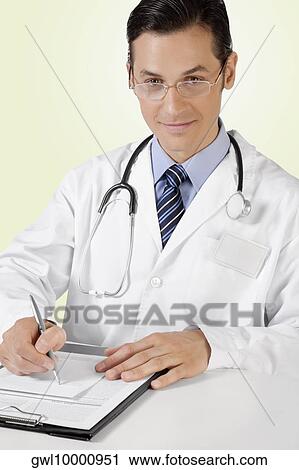 Portrait of a doctor writing on a clipboard View Large Photo Image Stock Image - Portrait of a doctor writing on a clipboard. Fotosearch