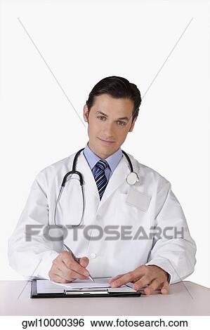 Portrait of a doctor writing on a clipboard View Large Photo Image Stock Photograph - Portrait of a doctor writing on a clipboard. Fotosearch