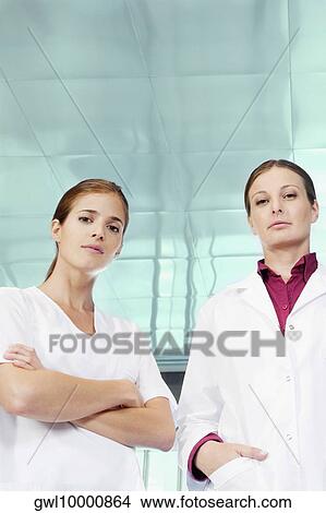 Portrait of a female doctor and a nurse standing together View Large Photo Image Picture - Portrait of a female doctor and a nurse standing together. Fotosearch