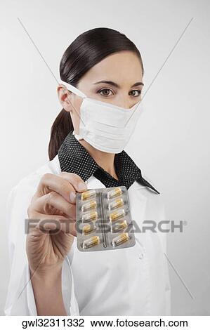 Portrait of a female doctor showing a blister pack of capsules View Large Photo Image Stock Image - Portrait of a female doctor showing a blister pack of capsules. Fotosearch