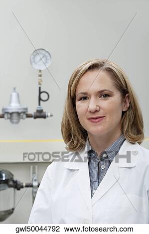Stock Image - Portrait of a female doctor smiling in a laboratory. Fotosearch