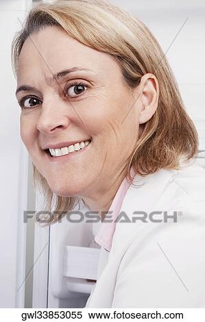 Portrait of a female doctor smiling in a laboratory View Large Photo Image Stock Photography - Portrait of a female doctor smiling in a laboratory. Fotosearch