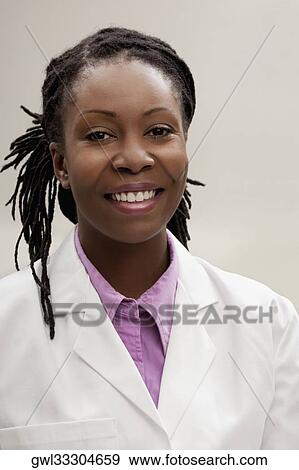 Portrait of a female doctor smiling View Large Photo Image Stock Photo - Portrait of a female doctor smiling. Fotosearch