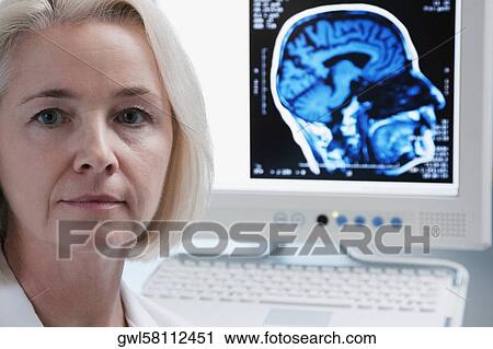 Portrait of a female doctor with an MRI scan of brain on a computer screen View Large Photo Image Stock Image - Portrait of a female doctor with an MRI scan of brain on a computer screen. Fotosearch