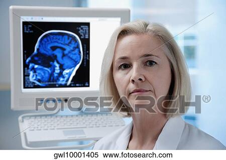 Portrait of a female doctor with an MRI scan of brain on a computer screen View Large Photo Image Stock Photography - Portrait of a female doctor with an MRI scan of brain on a computer screen. Fotosearch