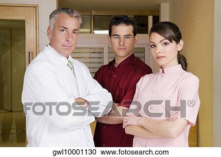 Portrait of a female doctor with male doctors View Large Photo Image Stock Image - Portrait of a female doctor with male doctors. Fotosearch