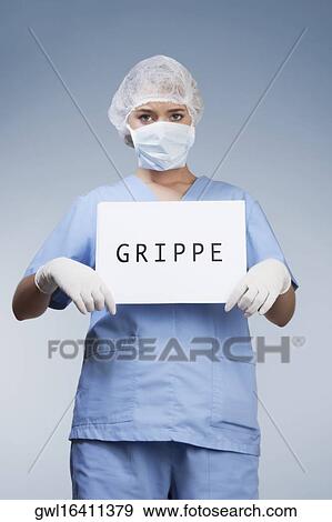 Portrait of a female surgeon showing a placard with word GRIPPE written on it View Large Photo Image Stock Photo - Portrait of a female surgeon showing a placard with word GRIPPE written on it. Fotosearch