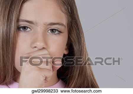 Stock Image - Portrait of a girl coughing. Fotosearch