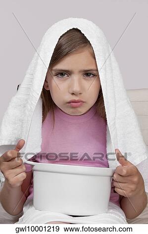 Stock Photo - Portrait of a girl inhaling steam. Fotosearch