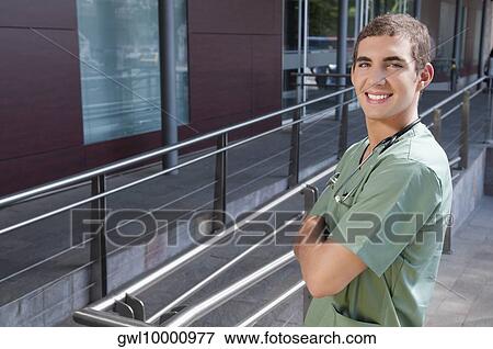 Portrait of a male nurse smiling View Large Photo Image Stock Photo - Portrait of a male nurse smiling. Fotosearch