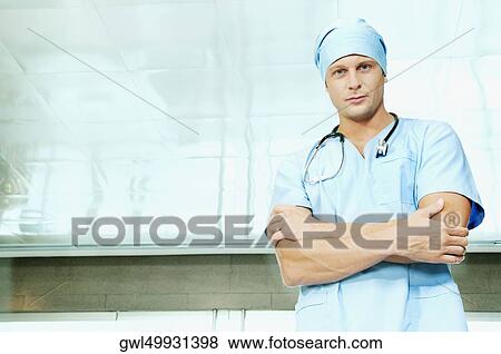 Portrait of a male surgeon standing with his arms crossed View Large Photo Image Stock Photo - Portrait of a male surgeon standing with his arms crossed. Fotosearch