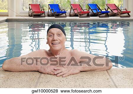 Portrait of a man leaning at the edge of a pool View Large Photo Image Stock Photo - Portrait of a man leaning at the edge of a pool. Fotosearch