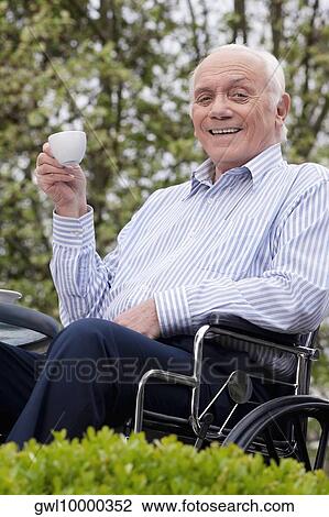 Portrait of a man sitting in a wheelchair and drinking tea View Large Photo Image Stock Image - Portrait of a man sitting in a wheelchair and drinking tea. Fotosearch
