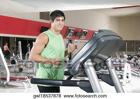 Stock Photo - Portrait of a man smiling on a treadmill. Fotosearch