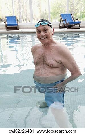 Portrait of a man standing and smiling in a swimming pool View Large Photo Image Stock Image - Portrait of a man standing and smiling in a swimming pool. Fotosearch