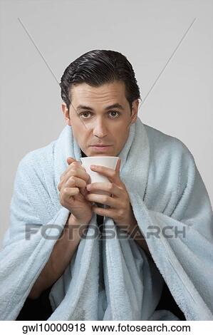 Stock Photo - Portrait of a man taking hot drink. Fotosearch