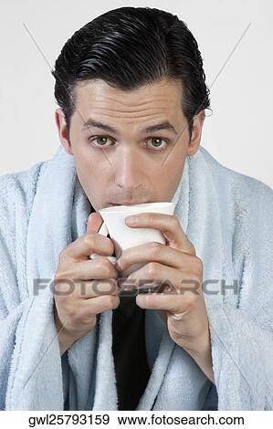 Portrait of a man taking hot drink View Large Photo Image Stock Photo - Portrait of a man taking hot drink. Fotosearch