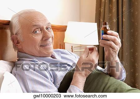 Portrait of a man taking medicine View Large Photo Image Stock Image - Portrait of a man taking medicine. Fotosearch