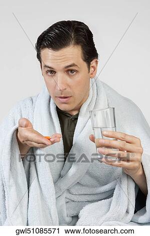 Portrait of a man taking medicine View Large Photo Image Stock Image - Portrait of a man taking medicine. Fotosearch