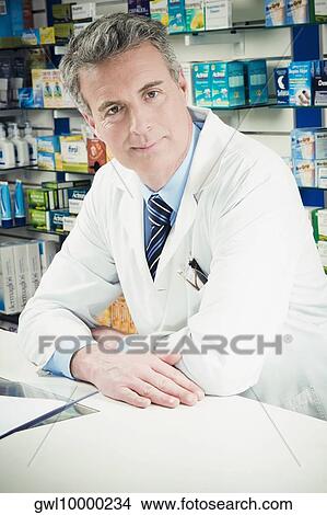 Portrait of a pharmacist in a pharmacy View Large Photo Image Picture - Portrait of a pharmacist in a pharmacy. Fotosearch