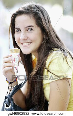 Portrait of a teenage girl eating an ice cream View Large Photo Image Stock Image - Portrait of a teenage girl eating an ice cream. Fotosearch