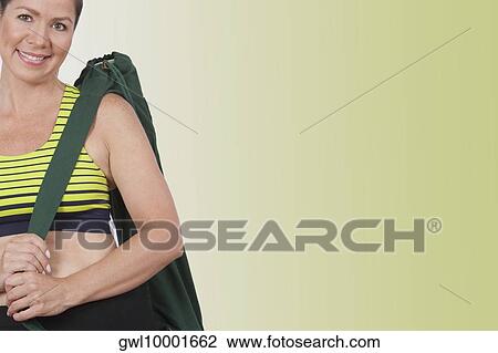 Portrait of a woman carrying a bag and smiling View Large Photo Image Stock Image - Portrait of a woman carrying a bag and smiling. Fotosearch