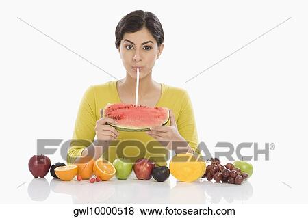 Portrait of a woman drinking from a watermelon with a straw View Large Photo Image Stock Photo - Portrait of a woman drinking from a watermelon with a straw. Fotosearch