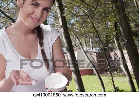 Portrait of a woman holding a bowl of moisturizer View Large Photo Image Stock Image - Portrait of a woman holding a bowl of moisturizer. Fotosearch