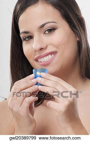Portrait of a woman holding a candle and smiling View Large Photo Image Stock Photo - Portrait of a woman holding a candle and smiling. Fotosearch