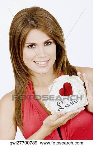 Portrait of a woman holding a gift View Large Photo Image Stock Photo - Portrait of a woman holding a gift. Fotosearch