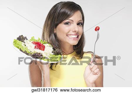 Stock Photograph - Portrait of a woman holding a salad. Fotosearch
