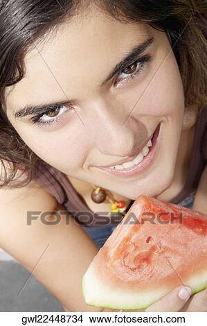 Portrait of a woman holding a slice of watermelon View Large Photo Image Picture - Portrait of a woman holding a slice of watermelon. Fotosearch